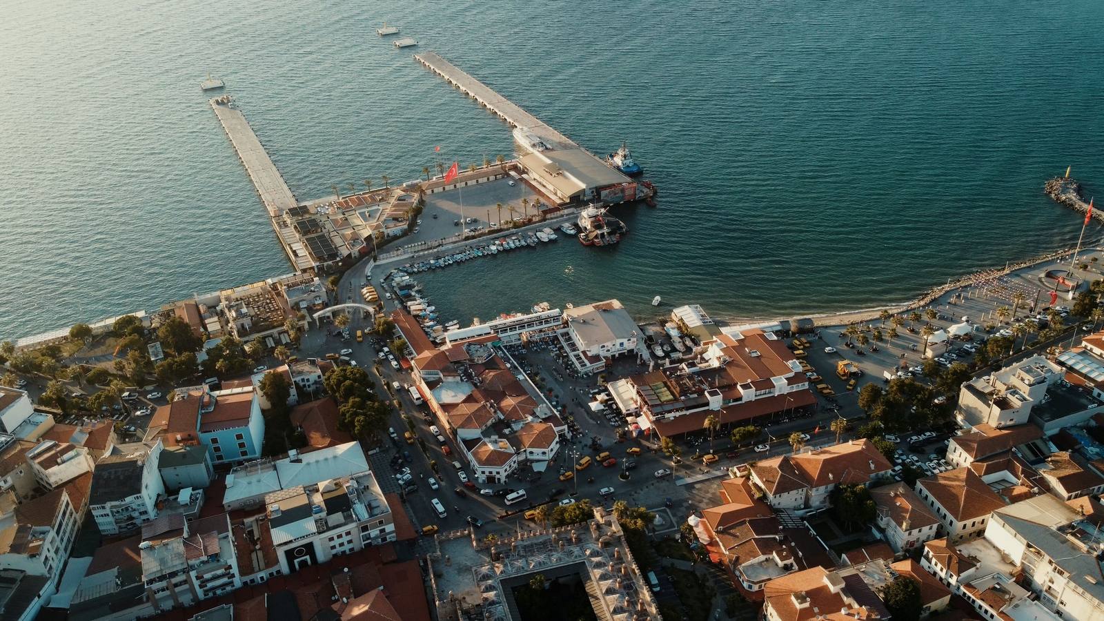 Aerial view of the two finger piers of Ege Port reaching out from the old town of Kusadasi