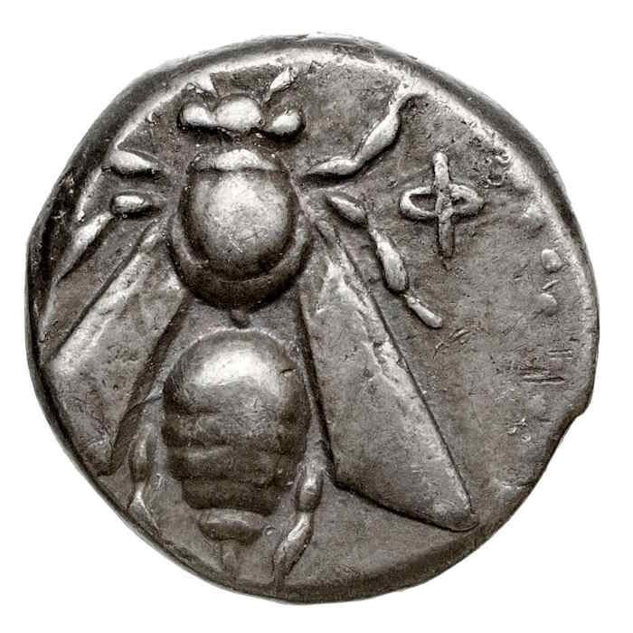 An ancient silver coin of Ephesus stamped with a bee seen from above, its wings spread