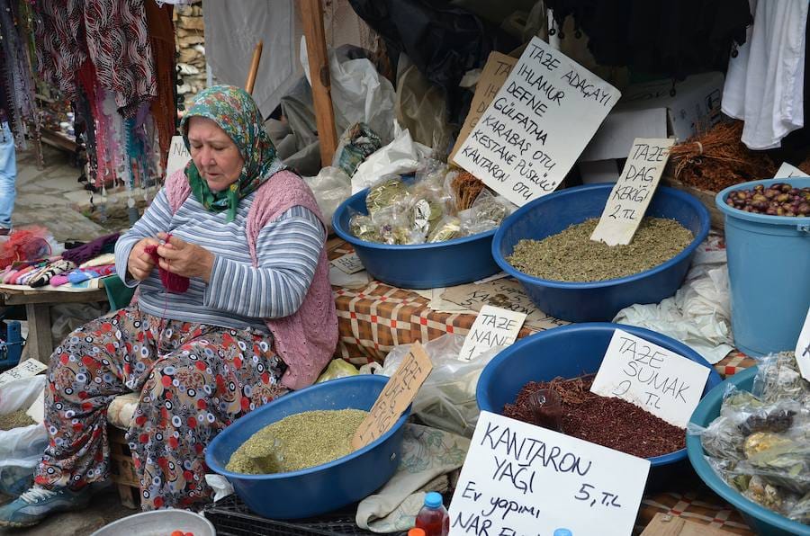A village woman selling dried herbs and spices at a street stall near Ephesus