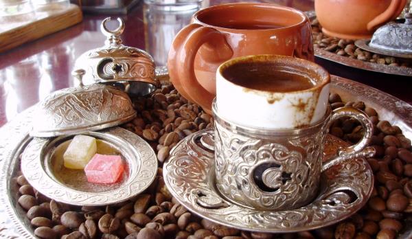 Traditional Turkish coffee in an ornate cup served with Turkish delight